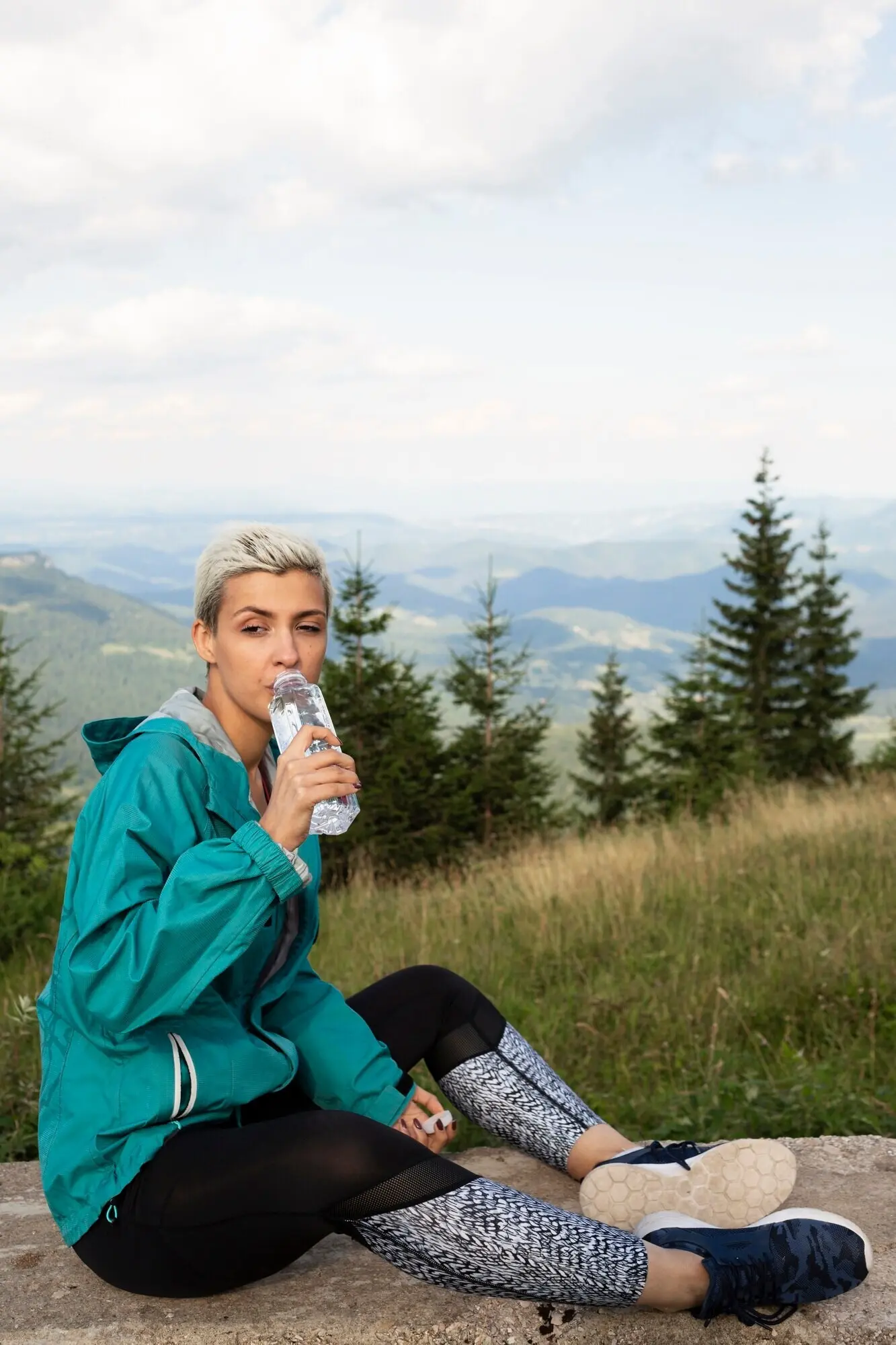Sportieve vrouw die een fles water vasthoudt.